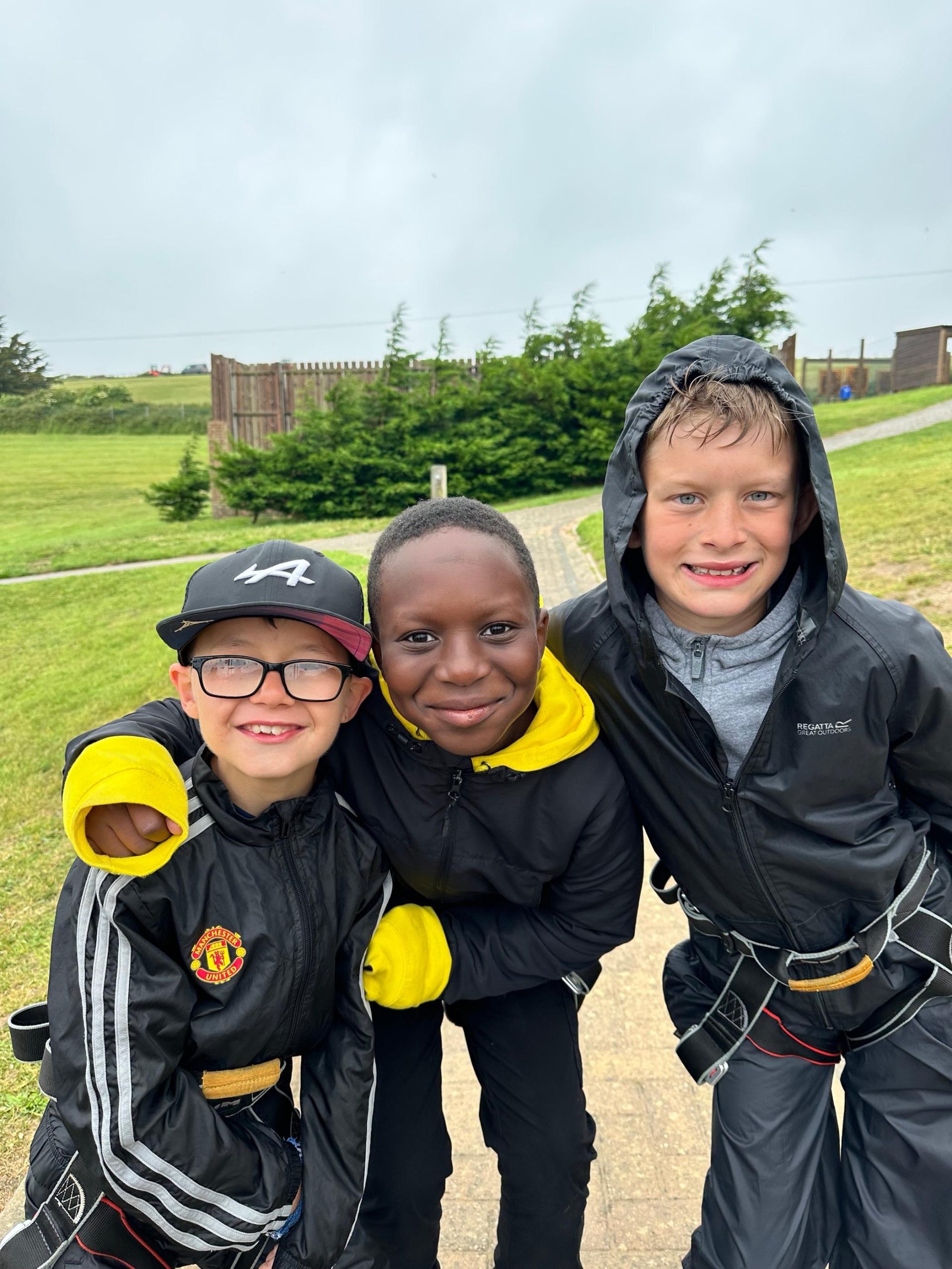 Three pupils smile on their residential trip.