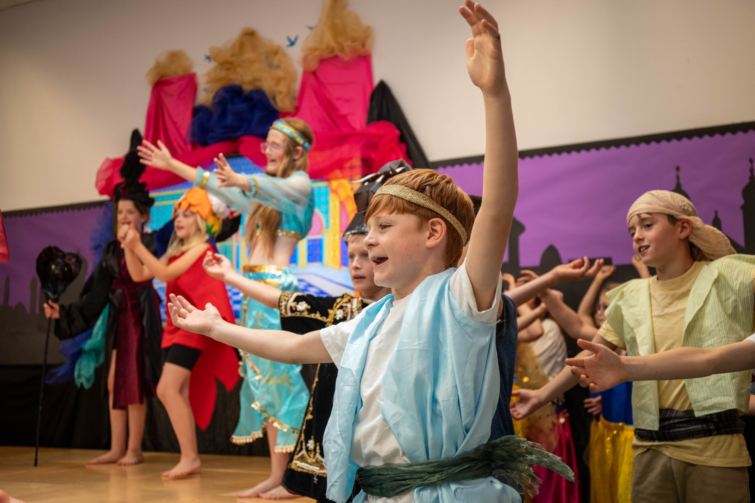 Children sing in the school musical and are happy.